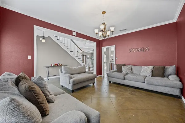 a living room with furniture and a chandelier