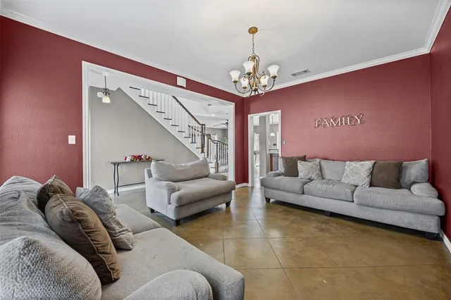 a living room with furniture and a chandelier