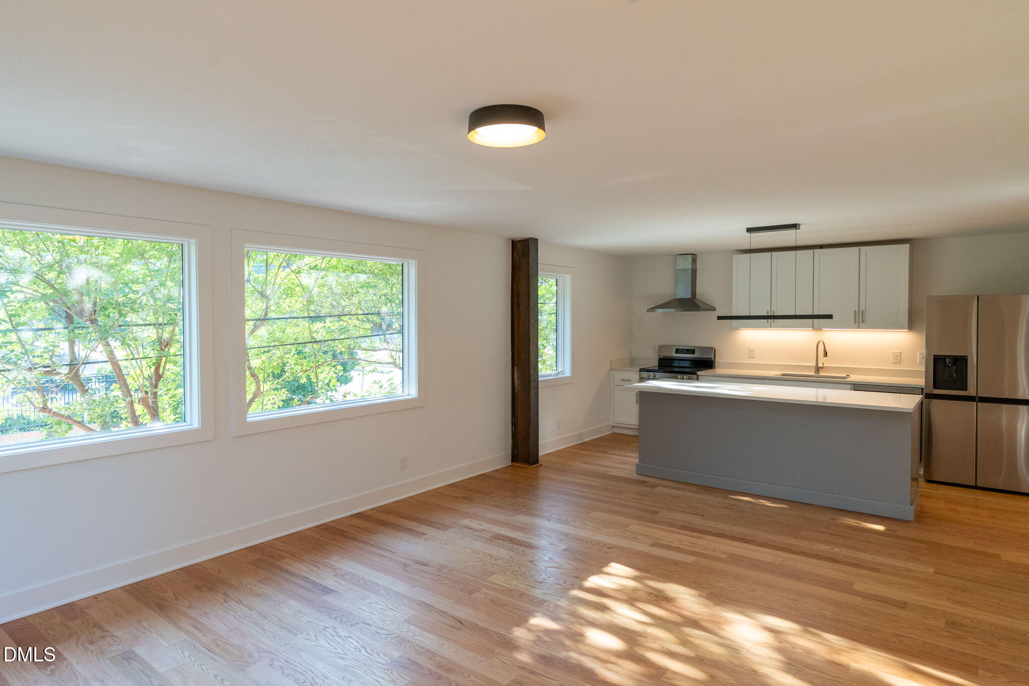 a kitchen with stainless steel appliances granite countertop a sink and window