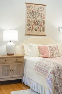 a bedroom with a bed and a painting on the wall