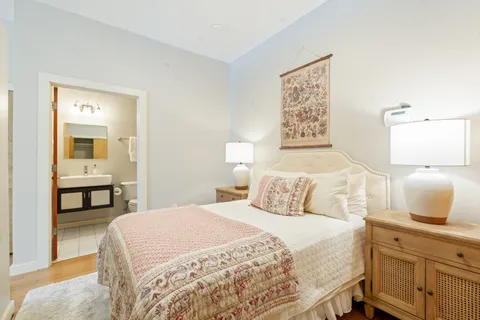 a bedroom with a bed and a view of bathroom