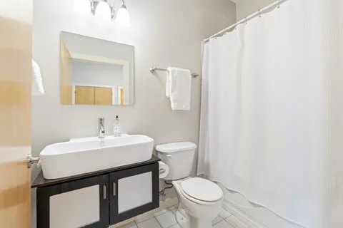a bathroom with a sink a toilet and mirror