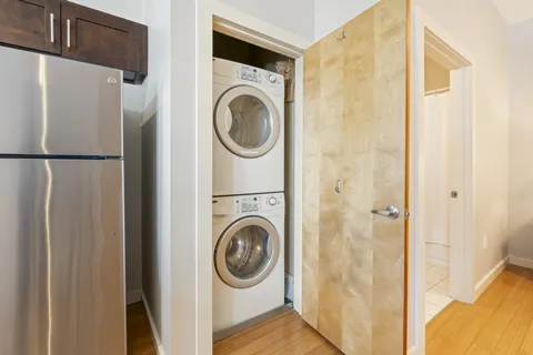 a view of a hallway with washer and dryer
