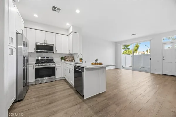 a kitchen with granite countertop a stove top oven and cabinets