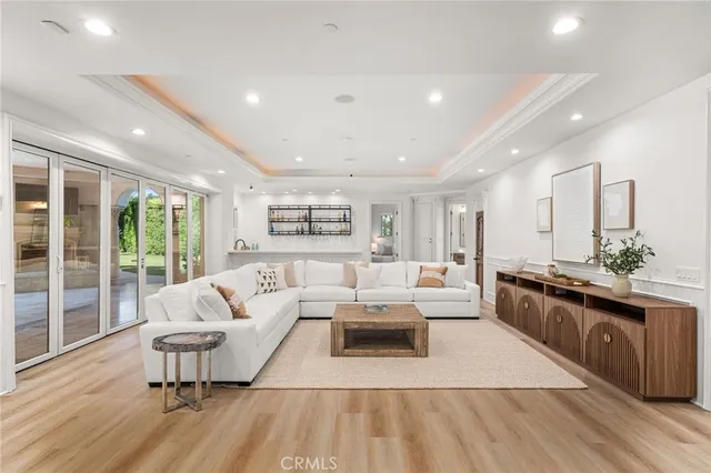 a view of a kitchen with furniture and wooden floor