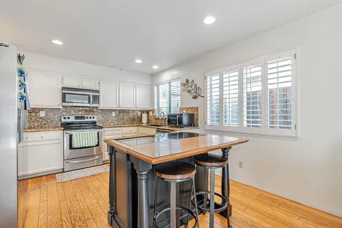 a kitchen with a stove a sink and a refrigerator