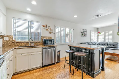 a kitchen with stainless steel appliances granite countertop a stove and cabinets