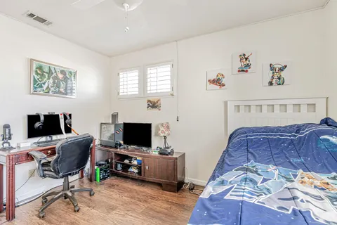 a bedroom with a workspace