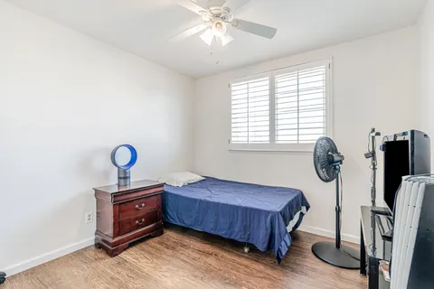 a bedroom with bed and a window