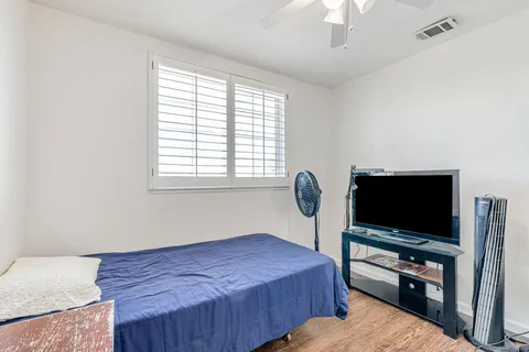 a bedroom with a bed and a flat screen tv