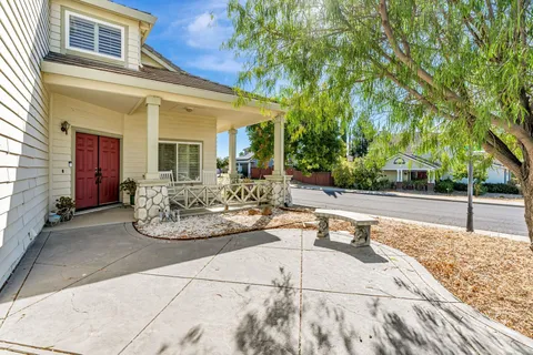 a view of a patio with table and chairs and potted plants