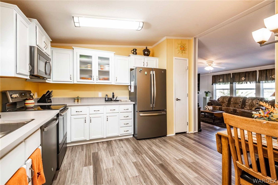 3285 Kelvin Road Golden Valley, AZ 86413 - Photo 12 of 43 a kitchen that has a lot of cabinets a sink and appliances in it