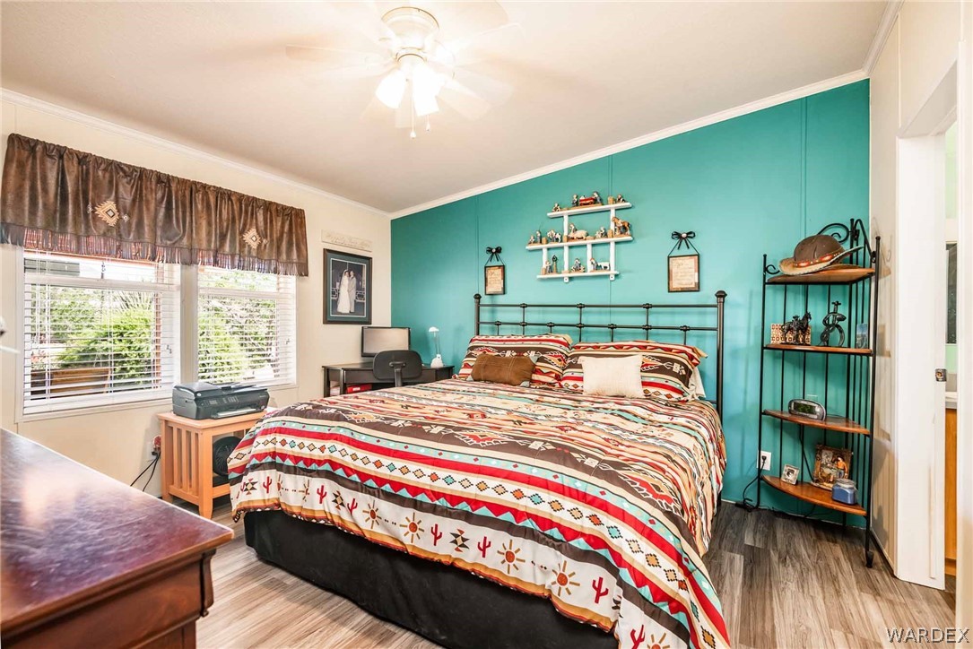 3285 Kelvin Road Golden Valley, AZ 86413 - Photo 17 of 43 a bedroom with a bed a dresser and a large window