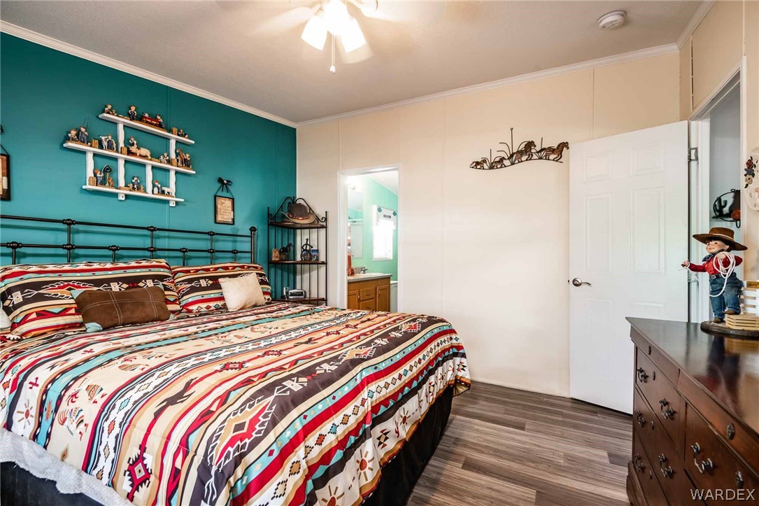 3285 Kelvin Road Golden Valley, AZ 86413 - Photo 18 of 43 a bedroom with double bed and a chandelier