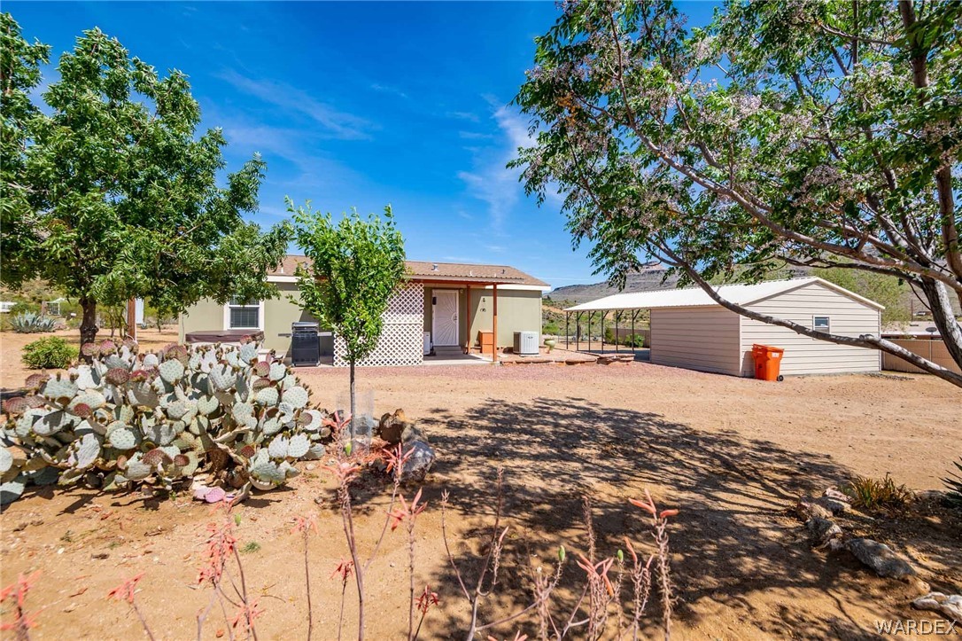 3285 Kelvin Road Golden Valley, AZ 86413 - Photo 34 of 43 a view of a house with a tree