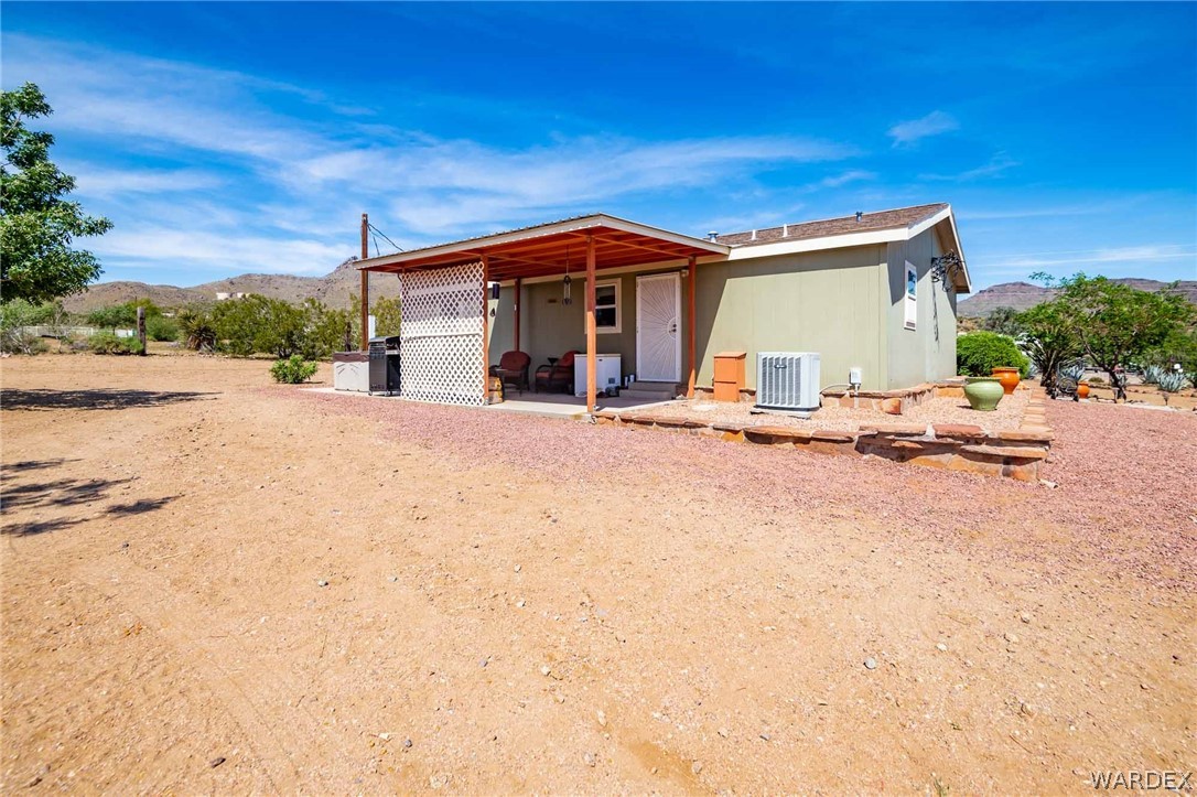 3285 Kelvin Road Golden Valley, AZ 86413 - Photo 36 of 43 a view of a house with backyard and sitting area