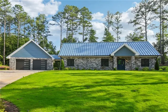 a front view of a house with yard and garage