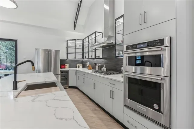 a kitchen with a sink and a stove top oven