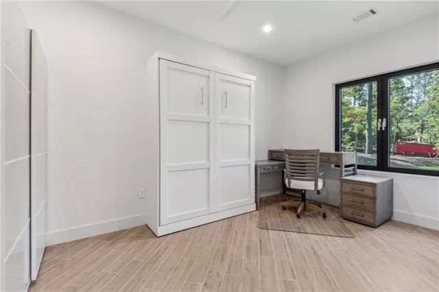 a view of a workspace with furniture and a window