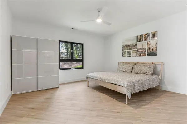a spacious bedroom with a bed and a cabinets