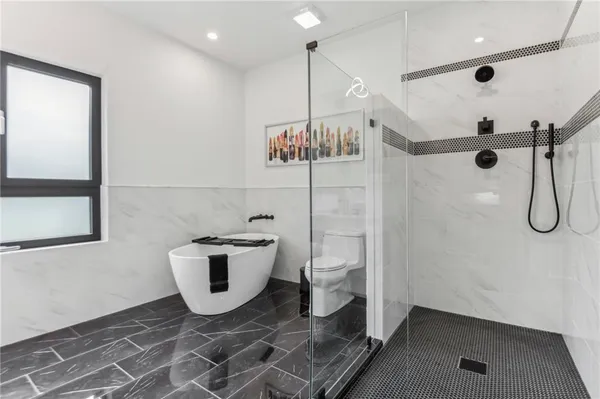a bathroom with a toilet and a shower
