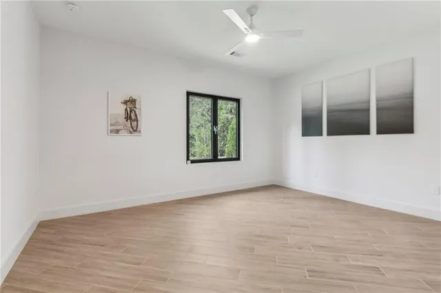 wooden floor in an empty room with a window
