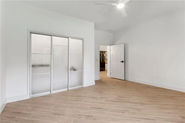 a view of an empty room with wooden floor