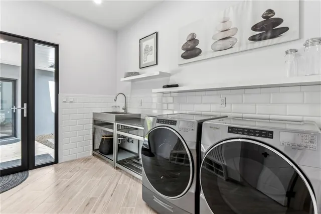 a utility room with sink dryer and washer