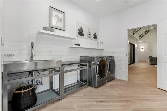a view of a kitchen with washing machine and a sink