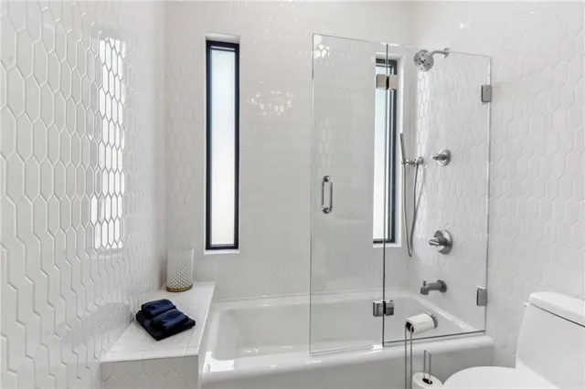 a bathroom with a bathtub a toilet and a shower