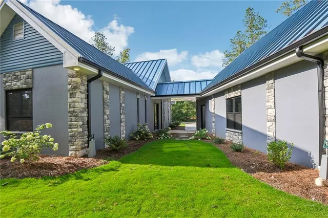 a view of a porch with a table and chairs and potted plants