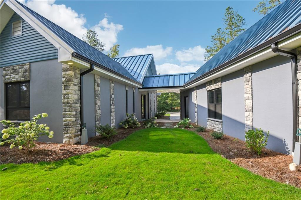 40 Red Oak Circle Buchanan, GA 30113 - Photo 37 of 39 a view of a porch with a table and chairs and potted plants