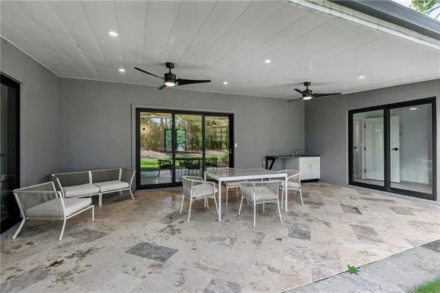 a dining room with furniture a chandelier and a rug