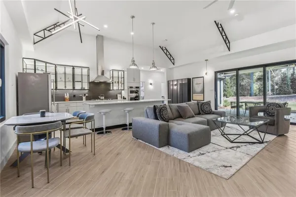 a living room with lots of furniture and a large window