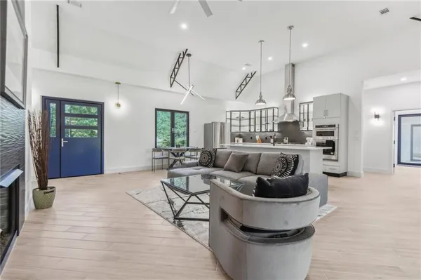 a living room with furniture and a wooden floor