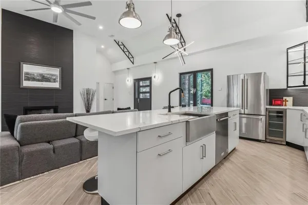 a kitchen with stainless steel appliances kitchen island granite countertop a stove and a refrigerator