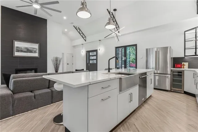 a kitchen with stainless steel appliances kitchen island granite countertop a stove and a refrigerator