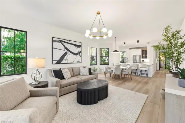 a living room with furniture and a chandelier