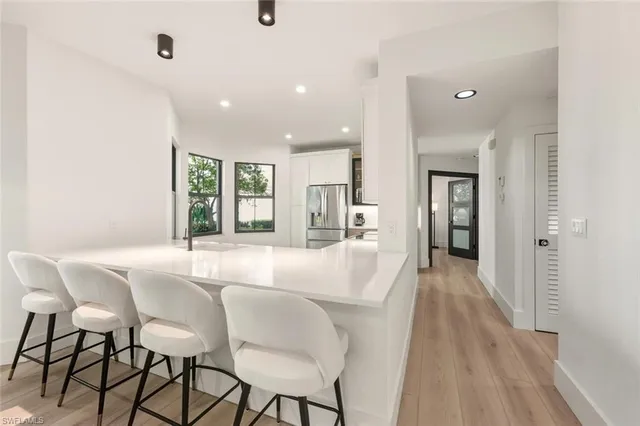 a dining room with furniture and a view of kitchen