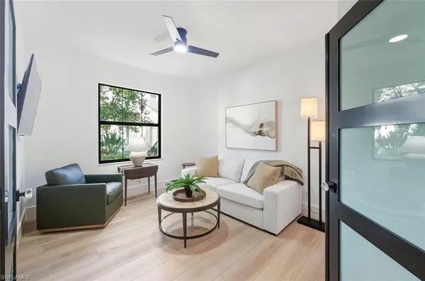 a living room with furniture and a large window