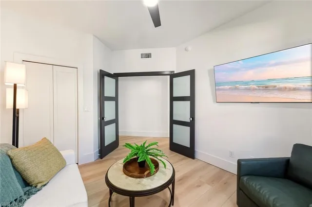 a living room with furniture and a potted plant
