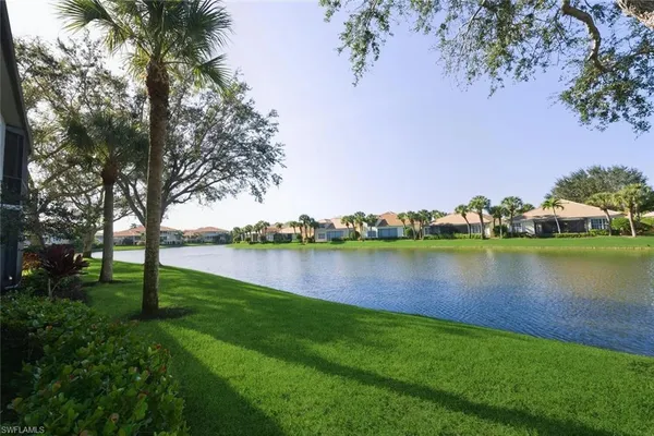 a view of a lake with houses in the back