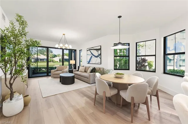 a dining room with furniture a chandelier and window