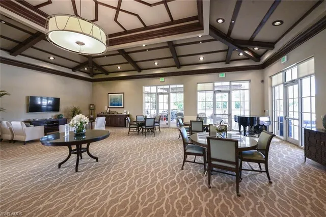 a front view of a house with a yard and palm trees