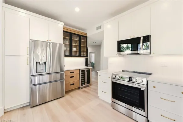 a kitchen with stainless steel appliances a stove microwave and refrigerator