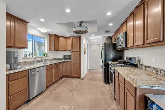 a kitchen with a sink stove and refrigerator