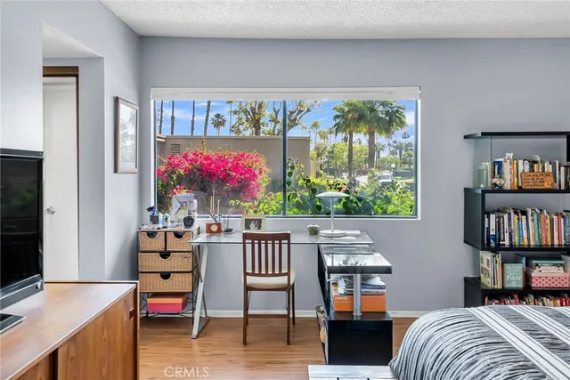 a living room with furniture a window and bookshelf