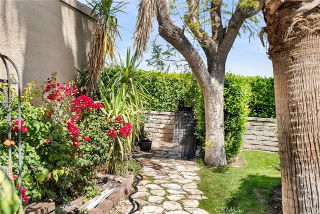 a backyard of a house with flower plants