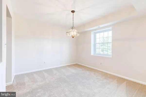 an empty room with windows and cabinet
