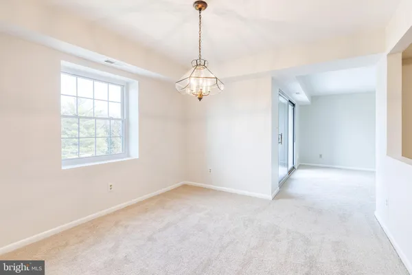 a view of a chandelier in big room and chandelier